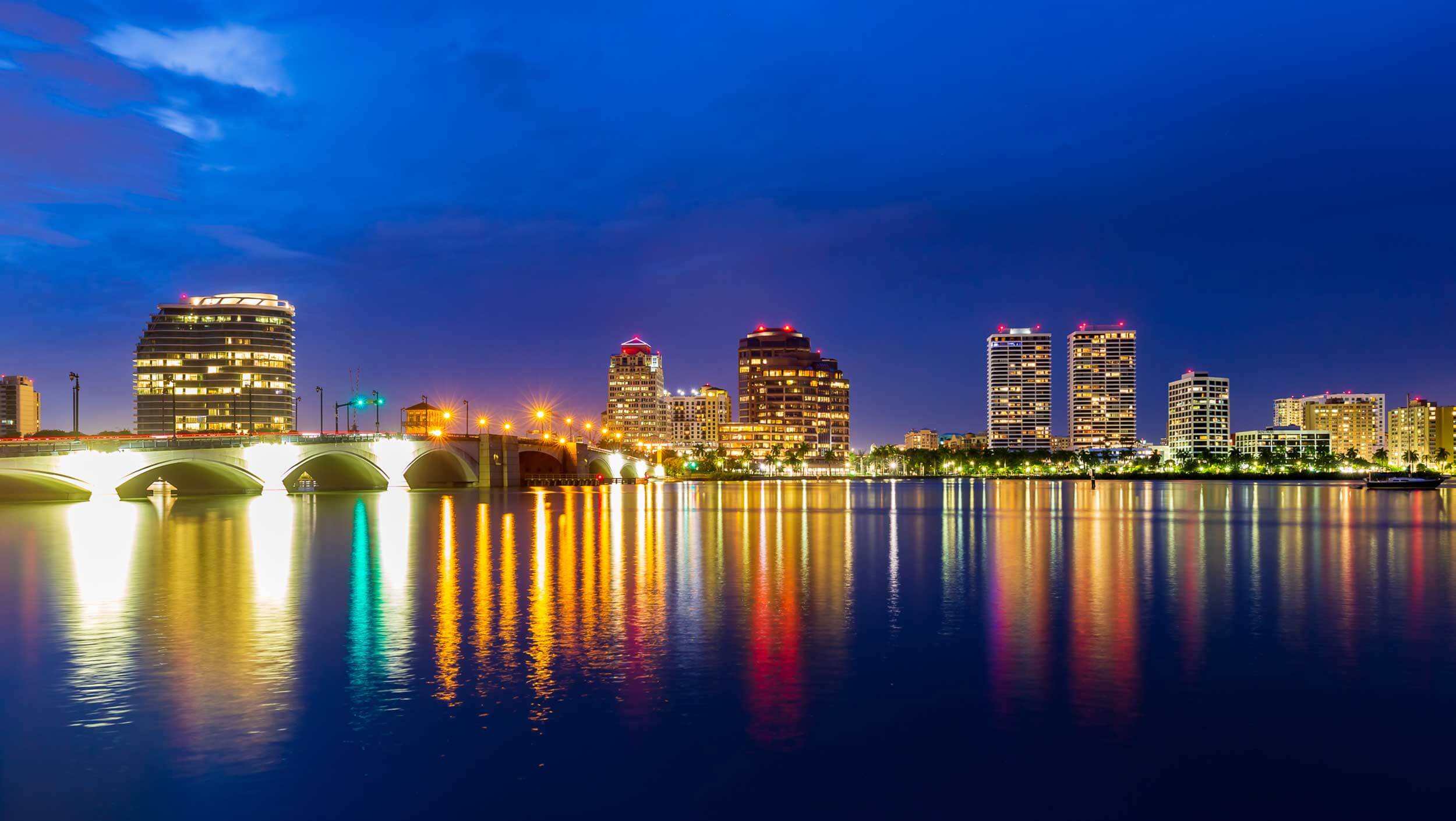 The West Palm Beach, Florida skyline reflected over a body of water